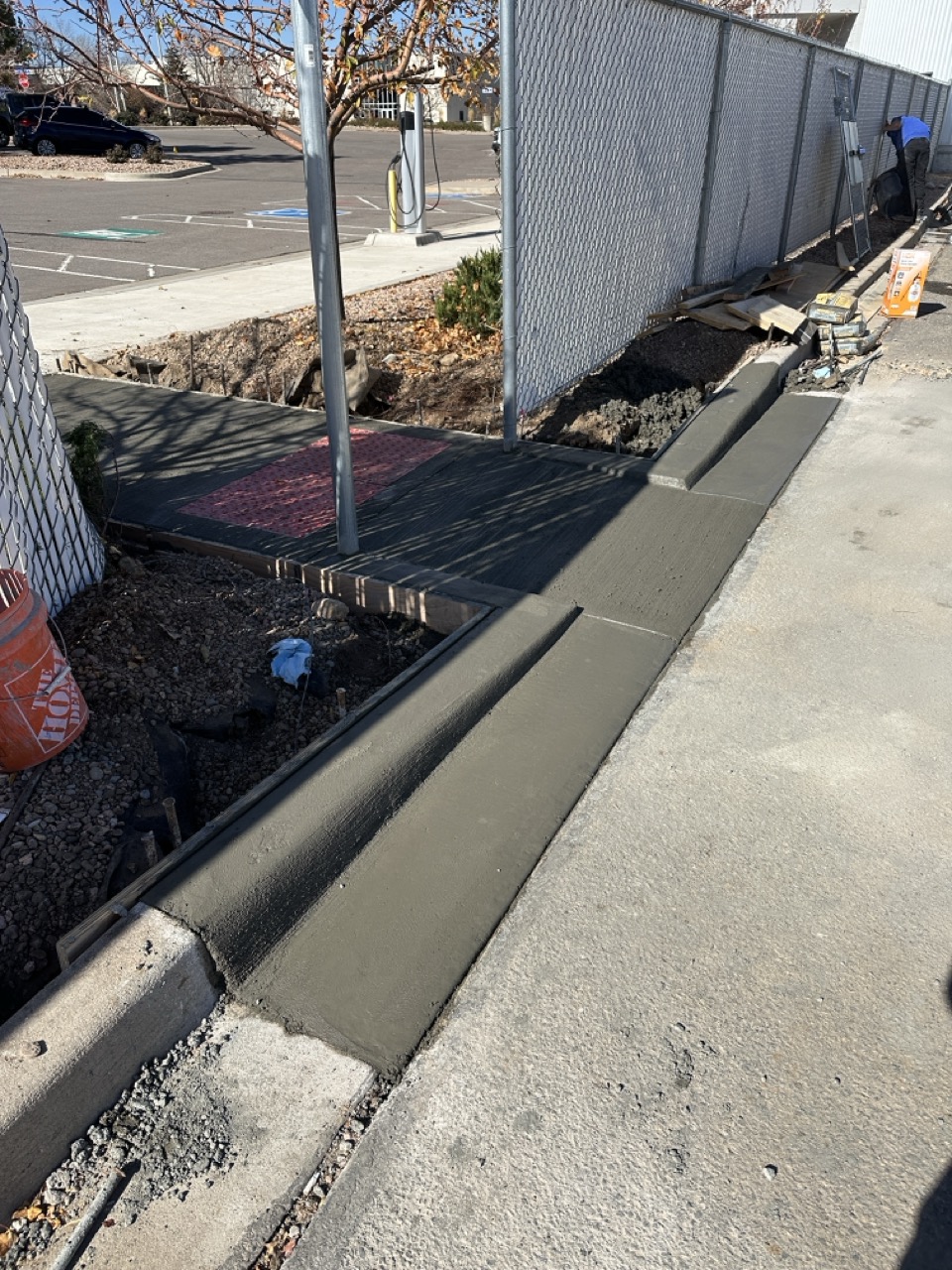 1 USE FOR CONCRETE Large Heavy machinery digging near a corrugated steel pipe.